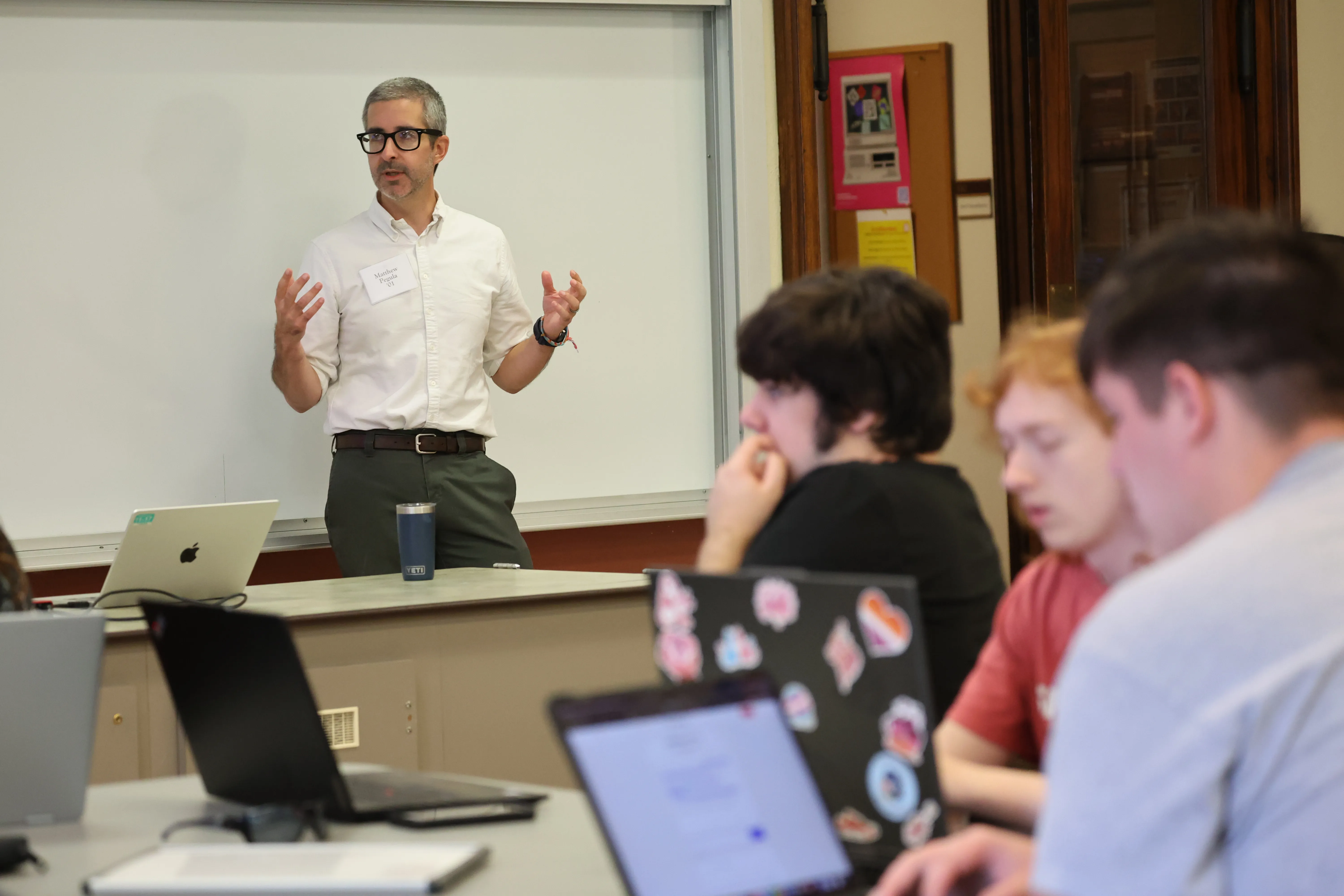 Professor presenting to students in a classroom